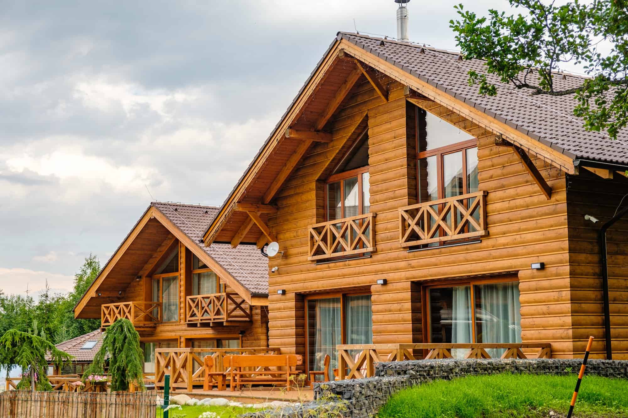 Modern wooden house with large windows in a suburban neighborhood